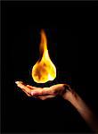 Hand holding burning flame