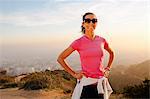 Smiling woman standing on hilltop