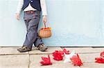 Boy holding basket of paper flowers