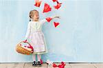 Smiling girl playing with paper flowers