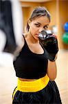 Woman kick boxing in gym