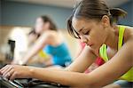 Woman using spin machine in gym