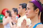 People practicing yoga in studio