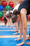 People practicing yoga in studio