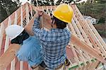 Carpenters working on rafter peak