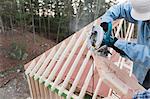 Carpenter using a circular saw to recut rafter bevel