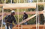 Carpenter measuring width of picture window frame