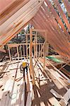 Carpenter working under rafters