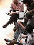 Businesspeople using digital tablet and laptop, high angle