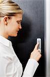 Woman pressing door keypad