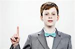 Boy pointing upwards with index finger