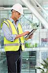 Engineer using digital tablet in office