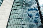 Cloudy blue sky reflected in office windows