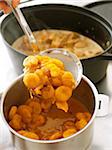 Cooked carrots and apricots in a cooking pot