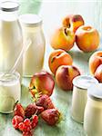 Yoghurts in glass pots,milk in glass bottle and fruit