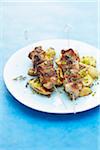 Veal brochettes with herbs,pan-fried potatoes with pistachios