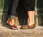 Italy, Venice, Couple standing by wooden door in old town