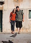 Italy, Venice, Couple walking in old town