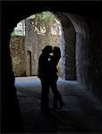 Italy, Ravello, Silhouettes of couple kissing in gate