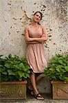 Italy, Ravello, Portrait of woman in dress leaning on wall