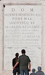 Italy, Rome, Spanish Steps, Rear view of couple standing in front of wall with latin inscriptions