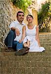 Italy, Ravello, Couple sitting on steps in old town