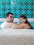 Italy, Amalfi Coast, Ravello, Mature couple looking over shoulder in swimming pool