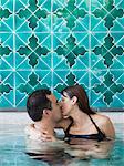 Italy, Amalfi Coast, Ravello, Mature couple kissing in swimming pool