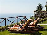 Italy, Amalfi Coast, Ravello, Mature couple lying on lounge chair