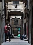 Italy, Venice, Young couple kissing in narrow street