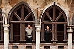 Italy, Venice, Couple standing in arcade