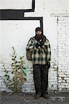 USA, Utah, Salt Lake City, Homeless man standing in front of brick wall