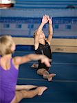 USA, Utah, Orem, Girls (6-9) stretching in gym