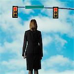 businessperson standing at a traffic signal