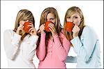 girls drinking from mugs