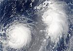 Typhoon Mawar And Tropical Cyclone Guchol, Western Pacific, In 2005, True Colour Satellite Image. Typhon Mawar (left) and Tropical Cyclone Guchol (right) on 22 August 2005, far out in the northwestern Pacific Ocean, some 900 kilometers from Tokyo. True-colour satellite image using MODIS data.