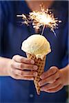 Woman Holding Vanilla Ice Cream Cone with Sparkler