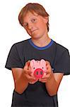Portrait of a skeptical looking boy holding his piggy bank on white background
