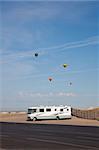 RV parked in Albuquerque. Hot air balloons flying above.