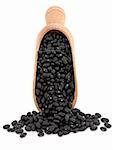 Black bean pulses in a wooden scoop over white background.