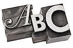 abc - first three alphabet letters in vintage letterpress metal type, isolated on white