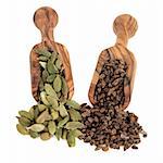 Cardamom pod and seed spice in olive wood scoops over white background.