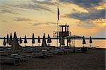 evening sunset on beach with sun beds and guardian towers