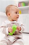 Young baby with block toy - closeup portrait