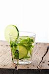 Mojito glass on a wooden table isolated on white