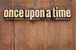 once upon a time opening phrase - storytelling concept - vintage letterpress wood type text against grunge weathered wooden background