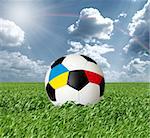 Soccer ball, Euro 2012 concept, ball with Ukraine and Poland flags, on green grass