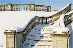 Snow-bound stone stair of park Petergof in sun winter weather