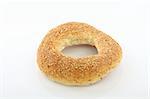 Close up of sesame bagel over white