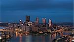 Panoramic image of Pittsburgh skyline at night.